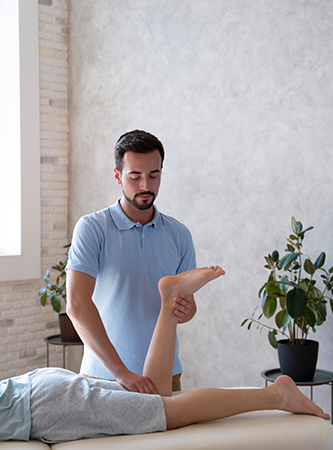 A therapist applying oil to a client's back in preparation for a massage.